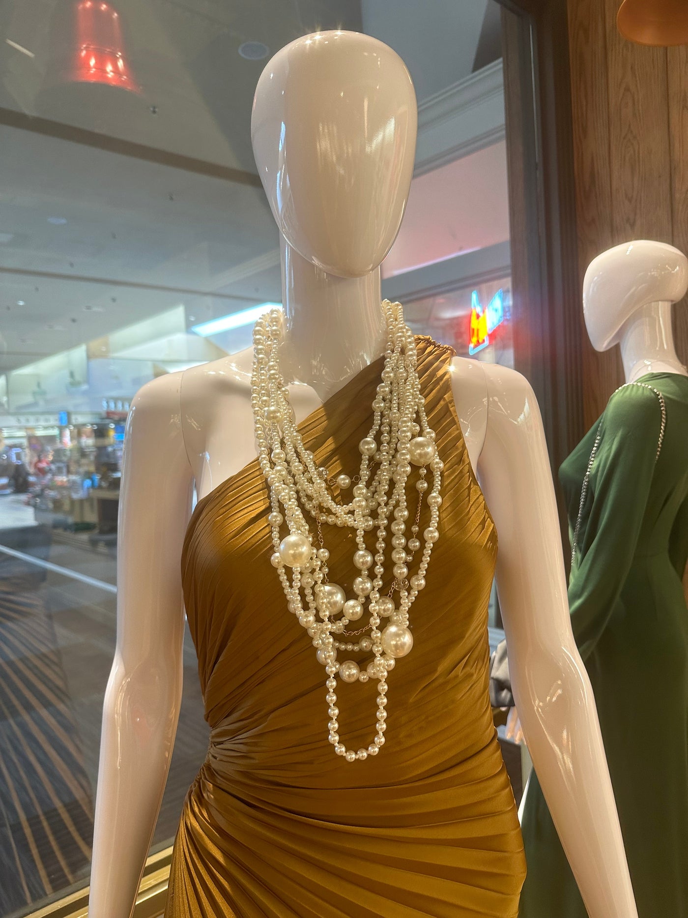 Mannequin displaying rich, long, multi layers of pearls. 