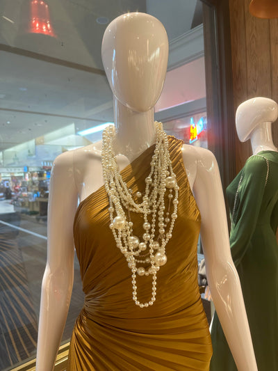 Mannequin displaying rich, long, multi layers of pearls. 